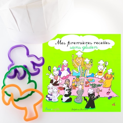 Kit du cordon bleu SANS GLUTEN Mes premières recettes Couverture du livre sur fondvert, 3 emporte-pièces à sablés vert, orange et violet et une toque en papier blanche à colorier.